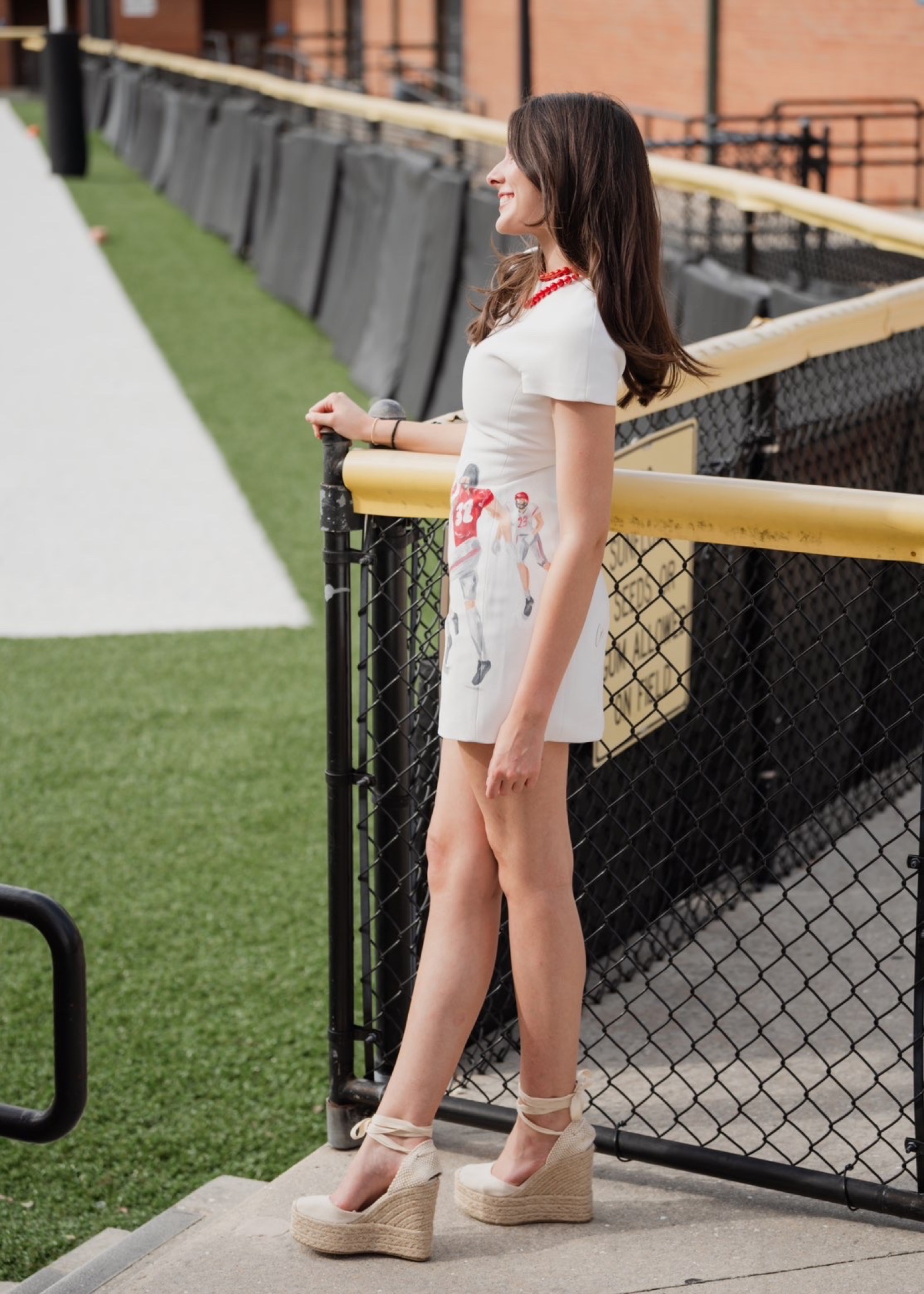 Side view of a hand-painted collegiate football dress at a stadium