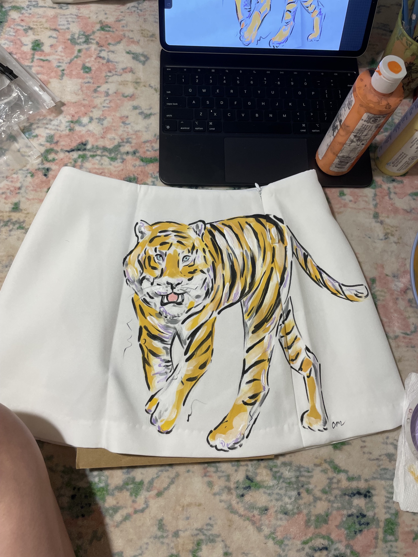 Hand-painted tiger artwork on cream fabric in the artist's studio